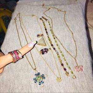4 pink rings, 3 necklaces, 2 bracelets, and 3 pen